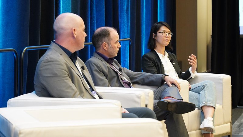 a group of panelist speaking on stage