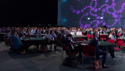 Delegates watching presentation from tables